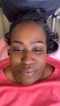 a woman laying on a bed with her eyes closed